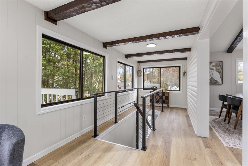 6 Henry Road Webster, MA 01570 - Photo 20 of 39 a view of a big room with wooden floor windows a chandelier and a glass table