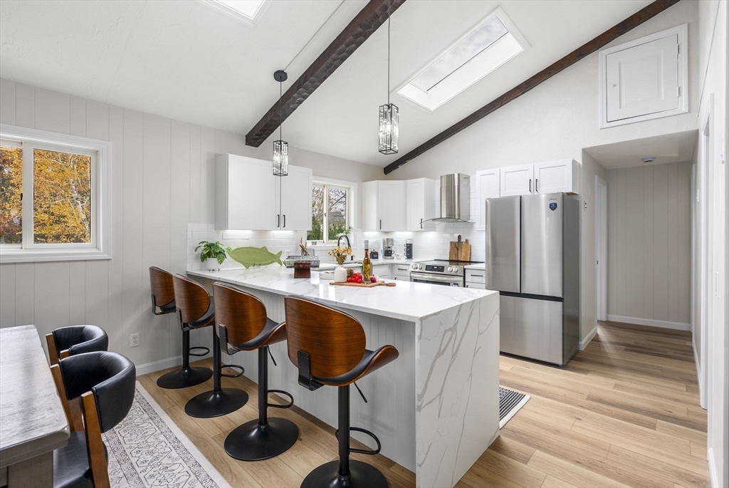 6 Henry Road Webster, MA 01570 - Photo 8 of 39 a kitchen with stainless steel appliances kitchen island granite countertop a table chairs and a refrigerator