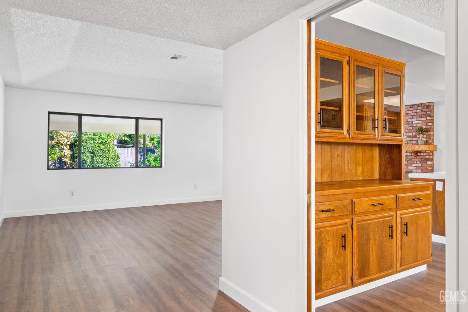 Undisclosed Address Bakersfield, CA 93314 - Photo 14 of 60 an empty room with wooden floor and windows