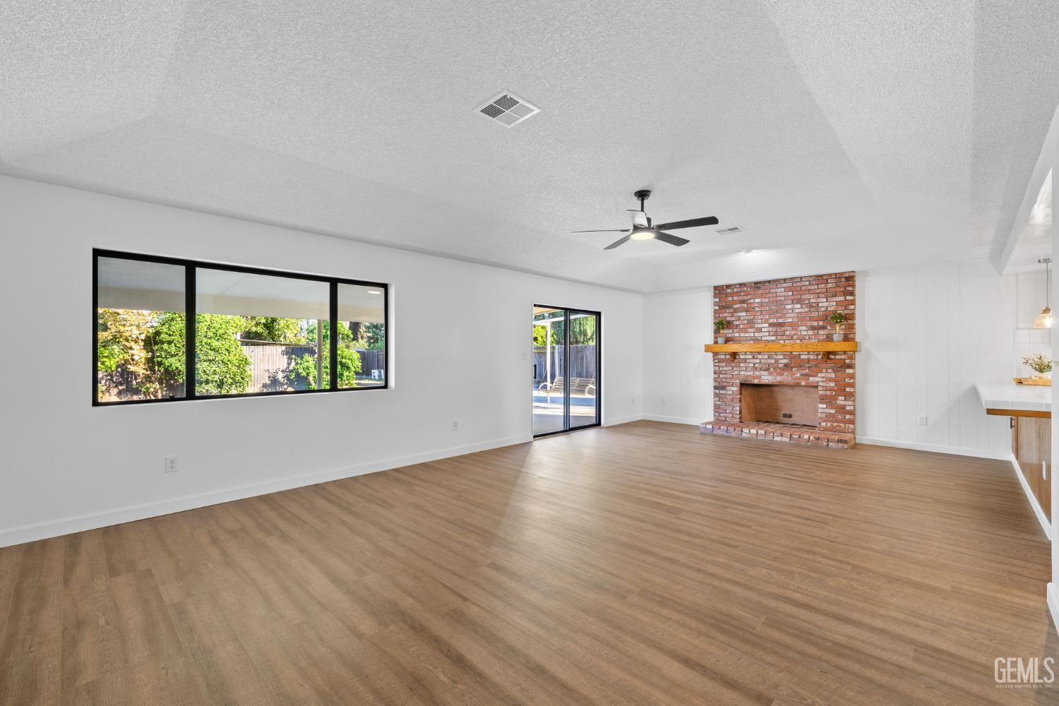 Undisclosed Address Bakersfield, CA 93314 - Photo 15 of 60 a view of an empty room with a window and wooden floor