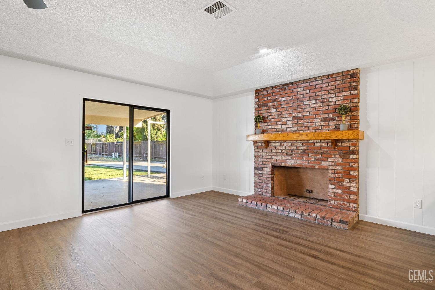 Undisclosed Address Bakersfield, CA 93314 - Photo 16 of 60 wooden floor fireplace and natural light in room