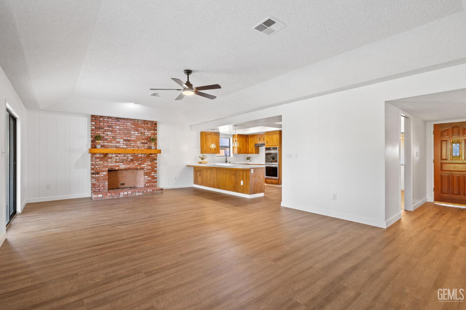 Undisclosed Address Bakersfield, CA 93314 - Photo 18 of 60 a view of an empty room with window and wooden floor