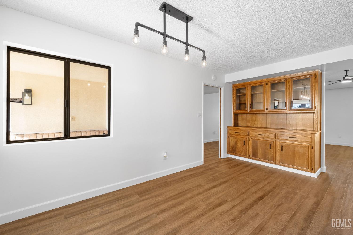 Undisclosed Address Bakersfield, CA 93314 - Photo 23 of 60 a room with wooden floor and cabinet