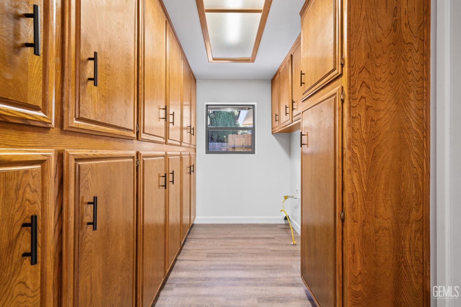 Undisclosed Address Bakersfield, CA 93314 - Photo 24 of 60 a view of a hallway with wooden floor and staircase