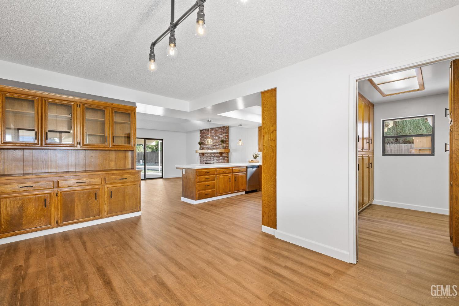 Undisclosed Address Bakersfield, CA 93314 - Photo 25 of 60 a view of a kitchen with wooden floor and a kitchen