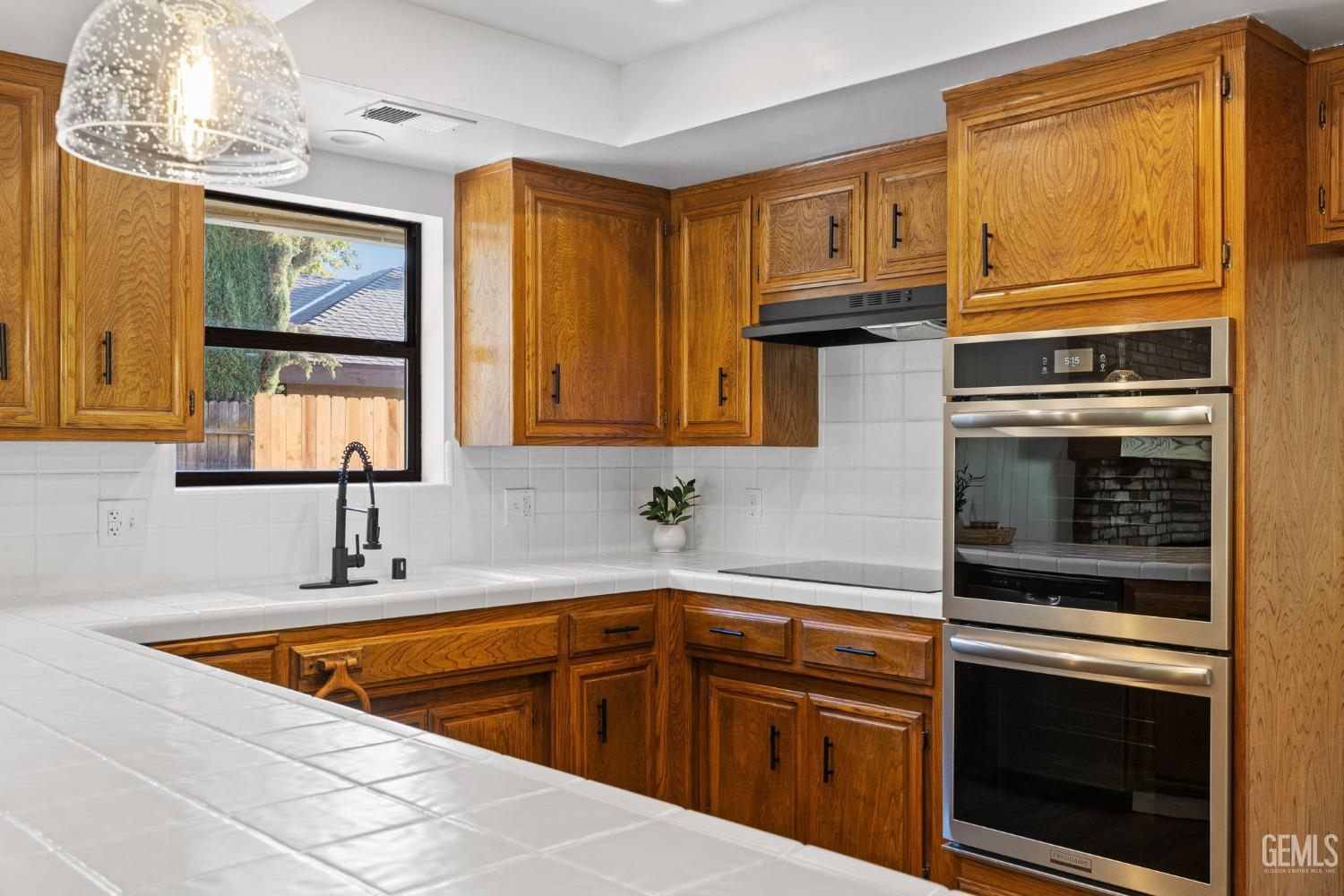 Undisclosed Address Bakersfield, CA 93314 - Photo 27 of 60 a kitchen with stainless steel appliances a stove sink and microwave