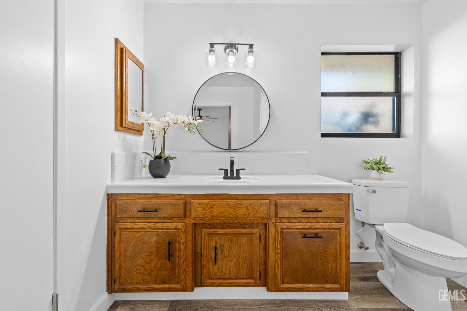 Undisclosed Address Bakersfield, CA 93314 - Photo 38 of 60 a bathroom with a toilet a sink and mirror