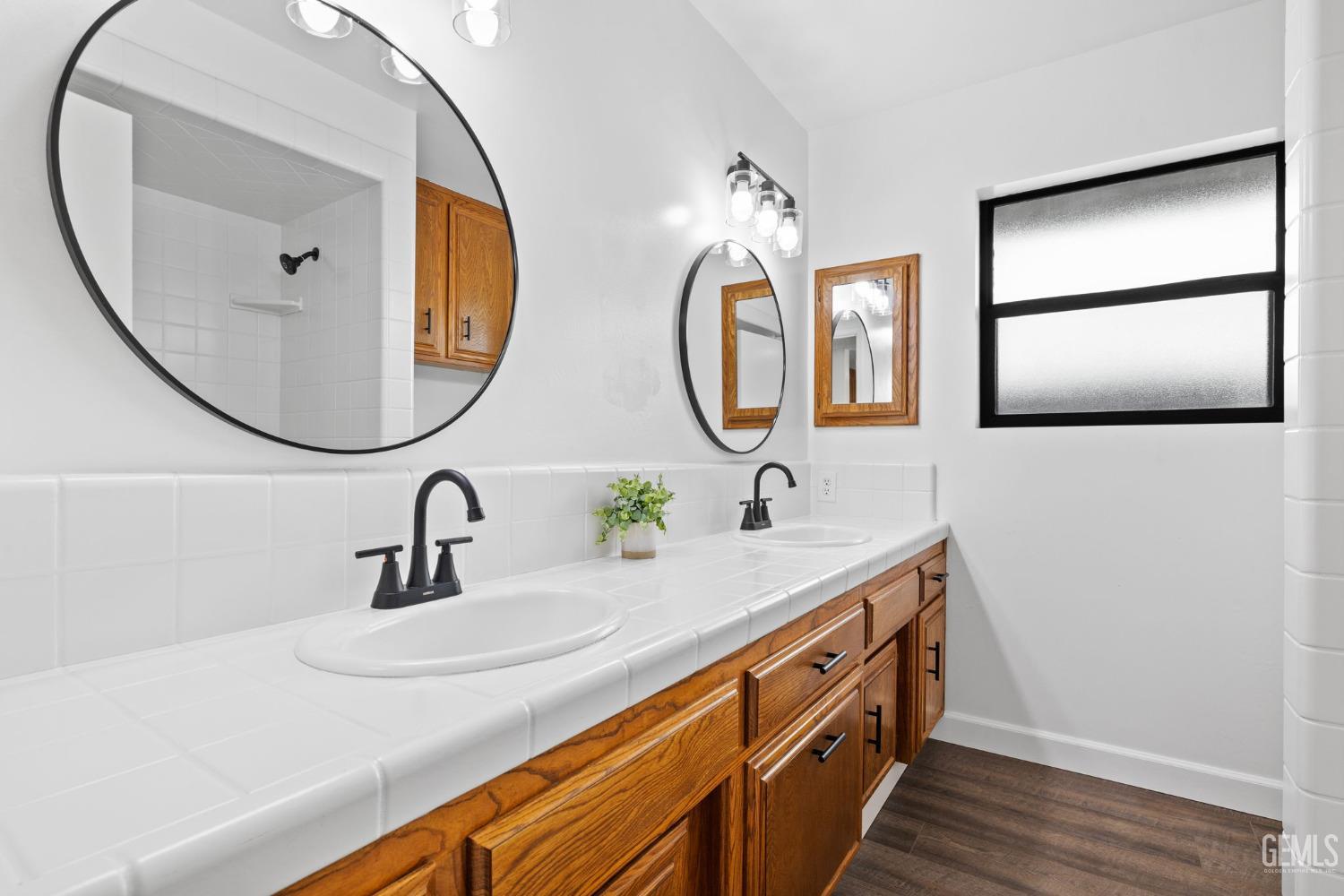 Undisclosed Address Bakersfield, CA 93314 - Photo 45 of 60 a bathroom with a sink and a mirror