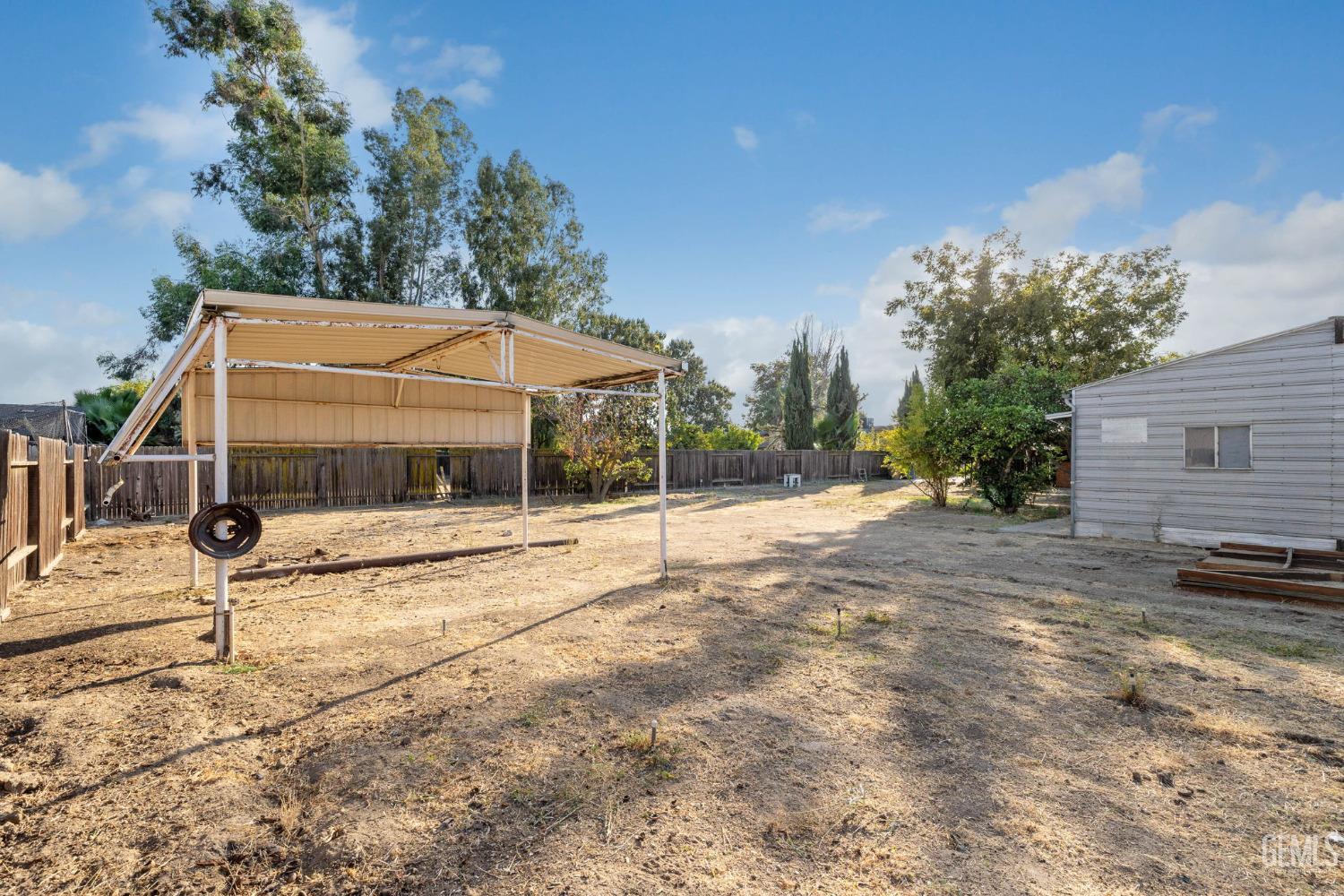 Undisclosed Address Bakersfield, CA 93314 - Photo 56 of 60 a view of a house with backyard and trees
