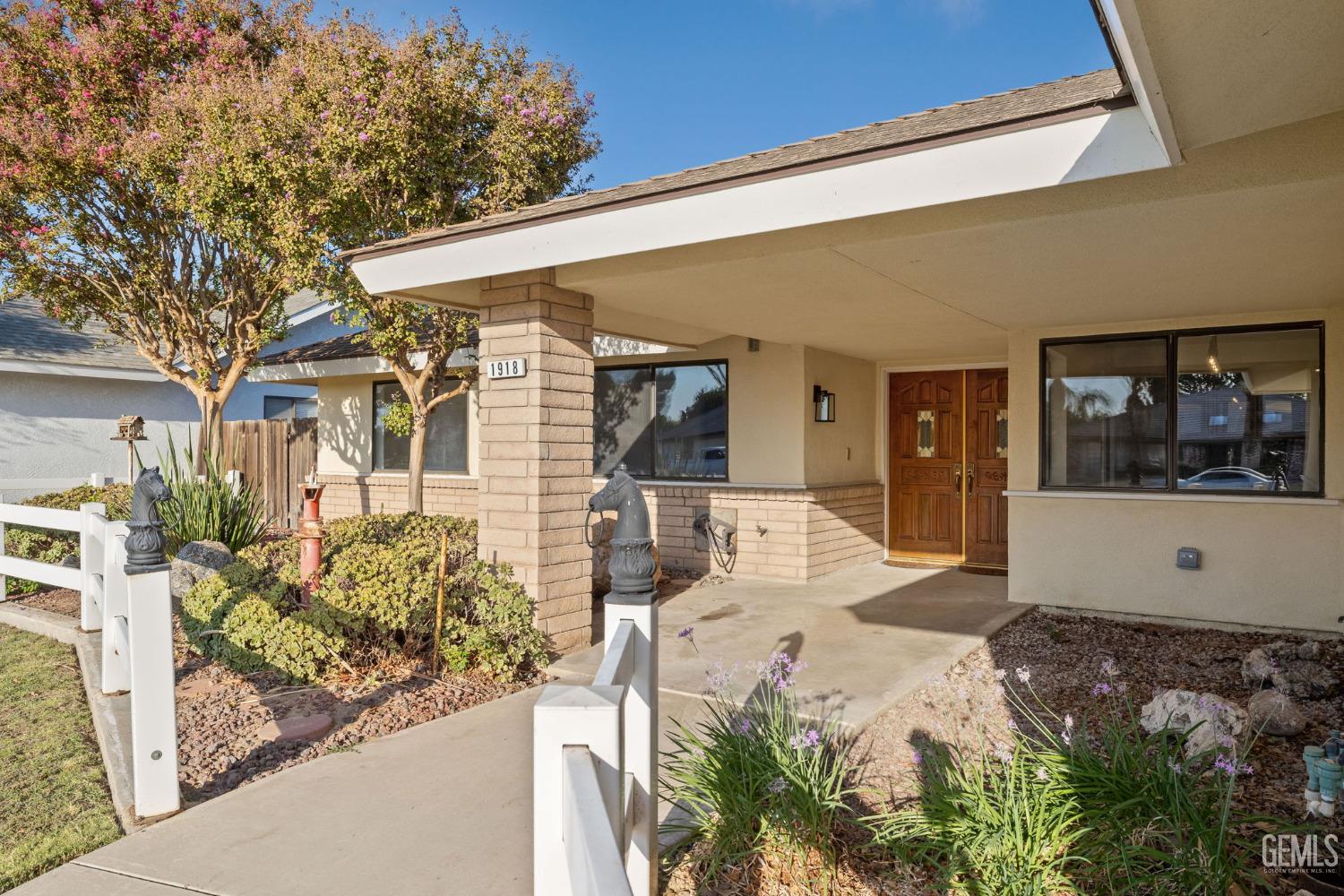 Undisclosed Address Bakersfield, CA 93314 - Photo 10 of 60 a front view of a house with a yard