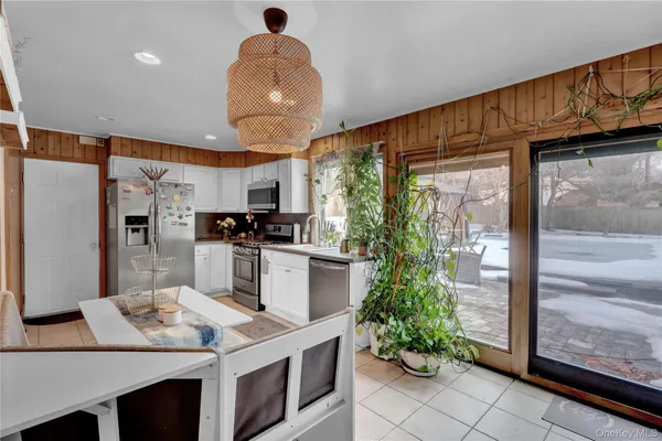 a kitchen with kitchen island granite countertop a counter space stainless steel appliances and cabinets
