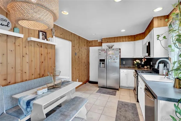 a kitchen with stainless steel appliances granite countertop a refrigerator a sink and a stove