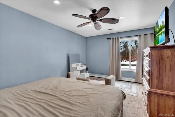a bedroom with a large bed and a large window