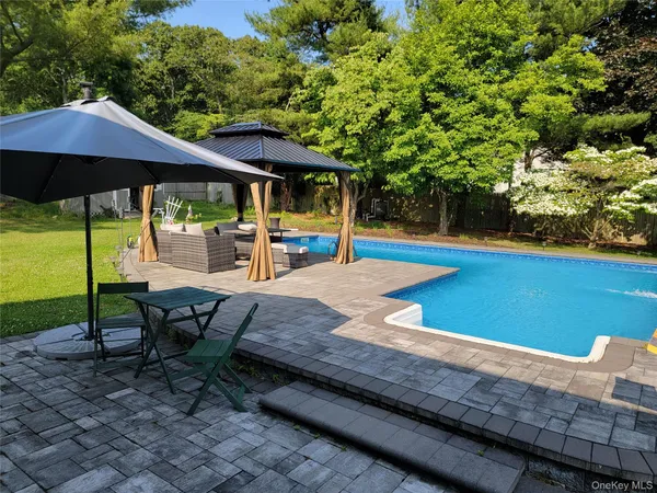 an outdoor space with furniture and umbrella