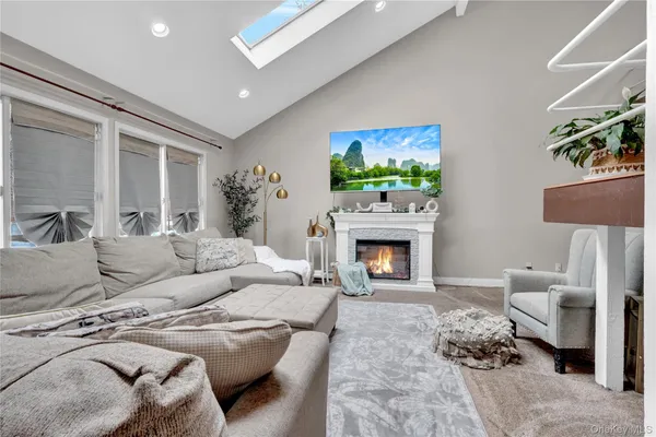 a living room with furniture a fireplace and a flat screen tv