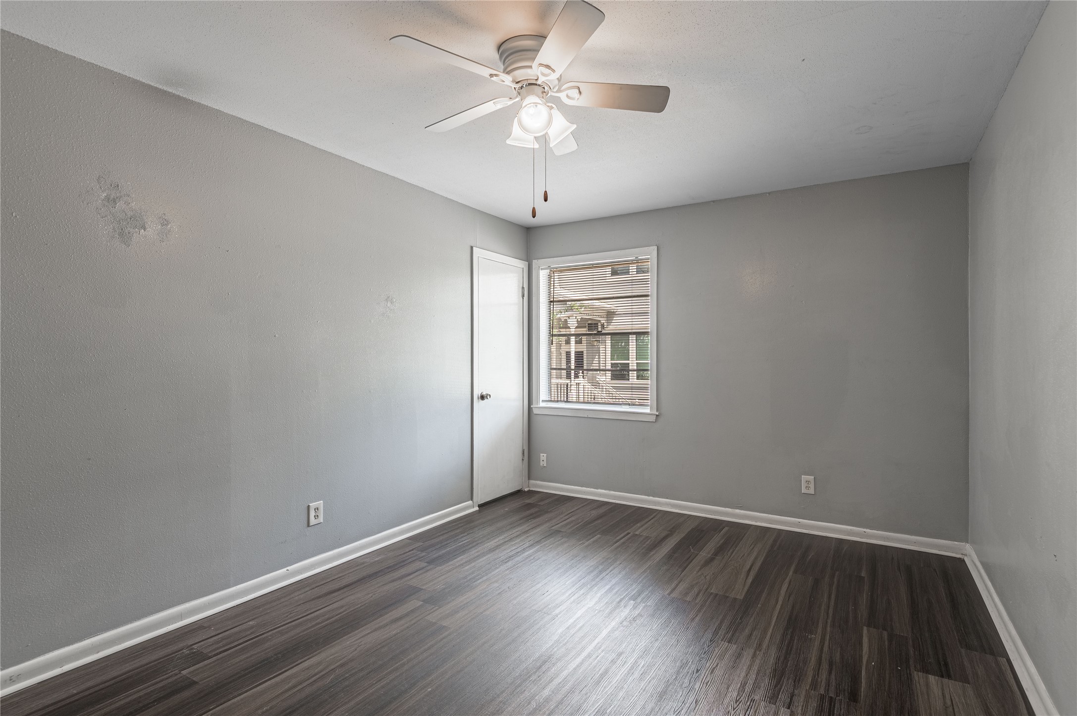 818 University Avenue, Unit 8 Huntsville, TX 77320 - Photo 11 of 22 wooden floor in an empty room with a window