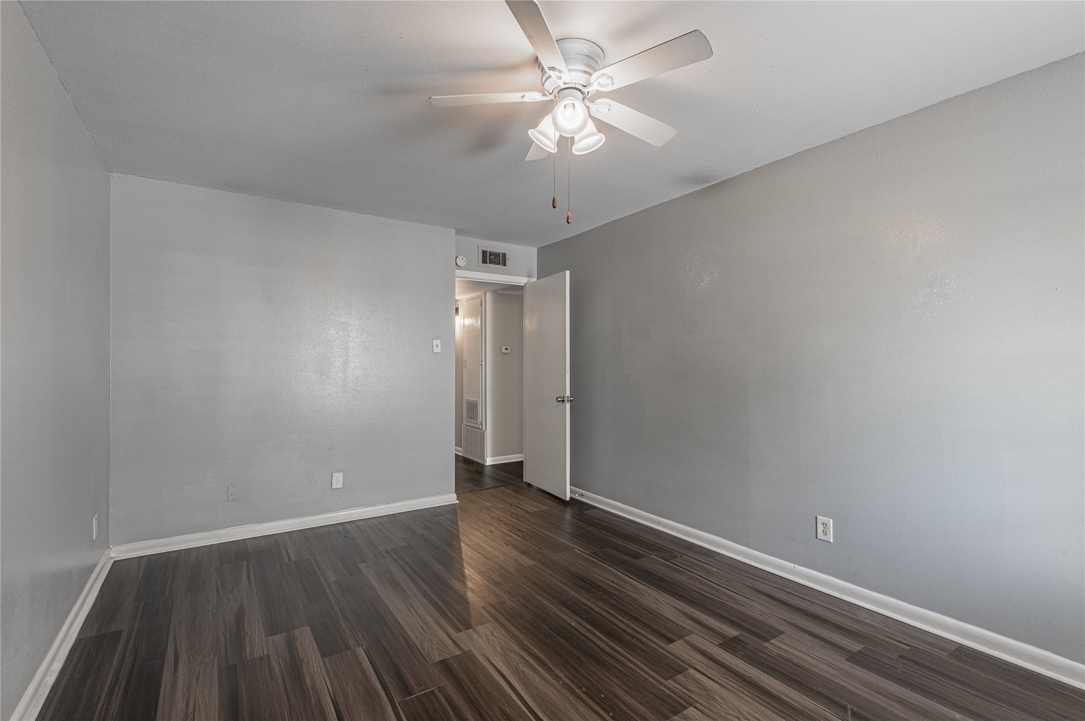 818 University Avenue, Unit 8 Huntsville, TX 77320 - Photo 12 of 22 a view of an empty room with wooden floor