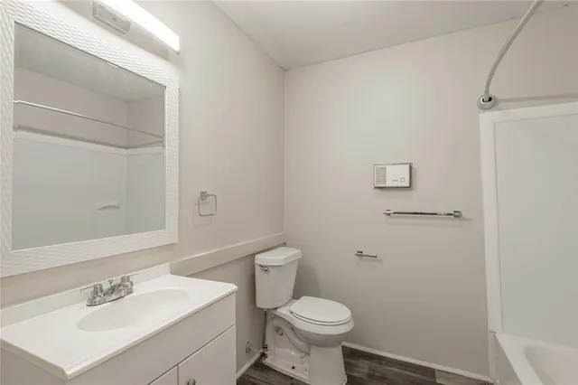 a bathroom with a sink toilet and a mirror