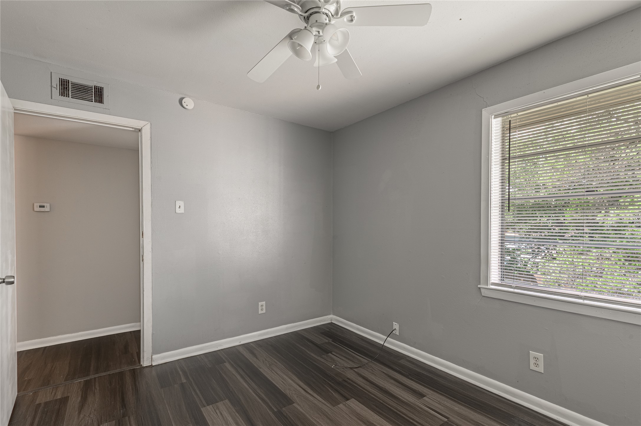 818 University Avenue, Unit 8 Huntsville, TX 77320 - Photo 15 of 22 an empty room with a window and a ceiling fan