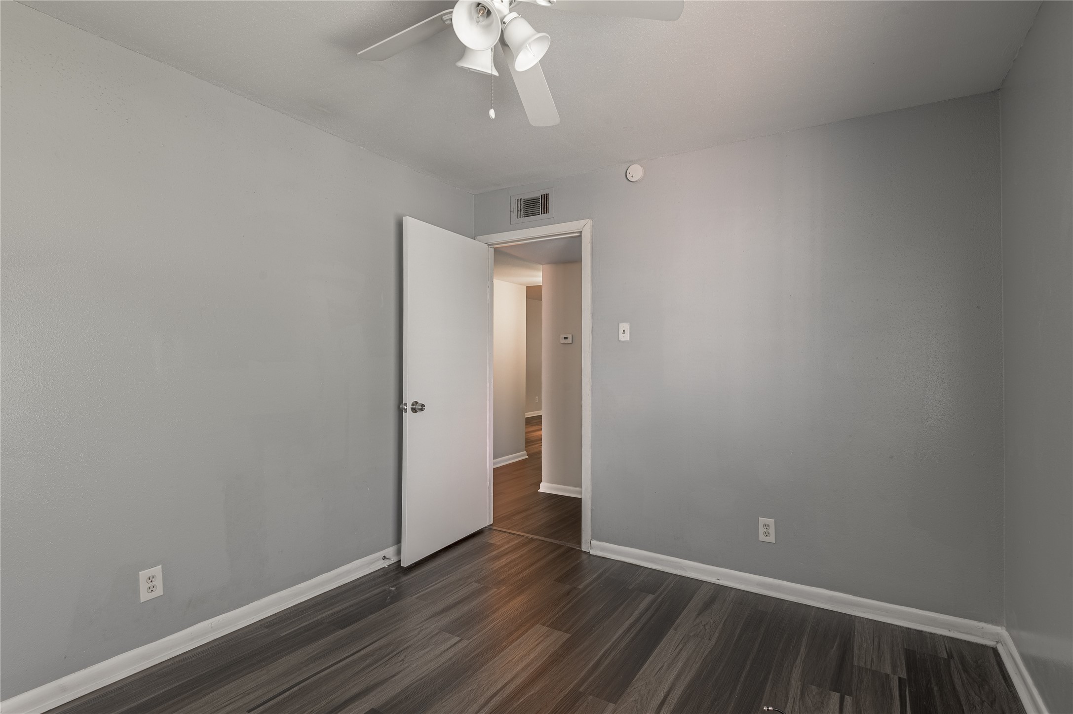 818 University Avenue, Unit 8 Huntsville, TX 77320 - Photo 16 of 22 a view of an empty room with wooden floor