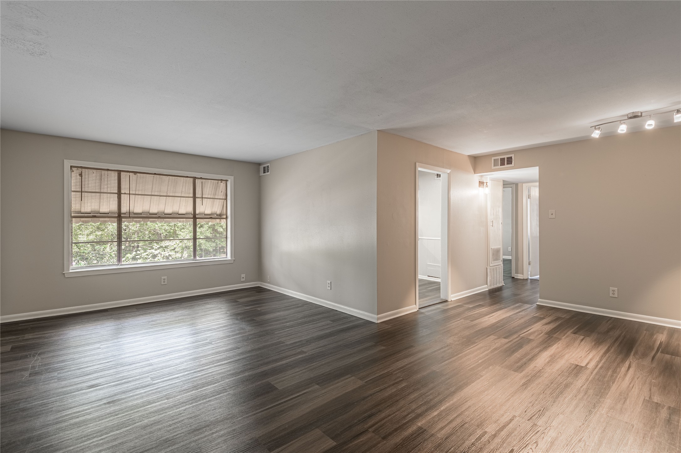 818 University Avenue, Unit 8 Huntsville, TX 77320 - Photo 3 of 22 an empty room with wooden floor and windows