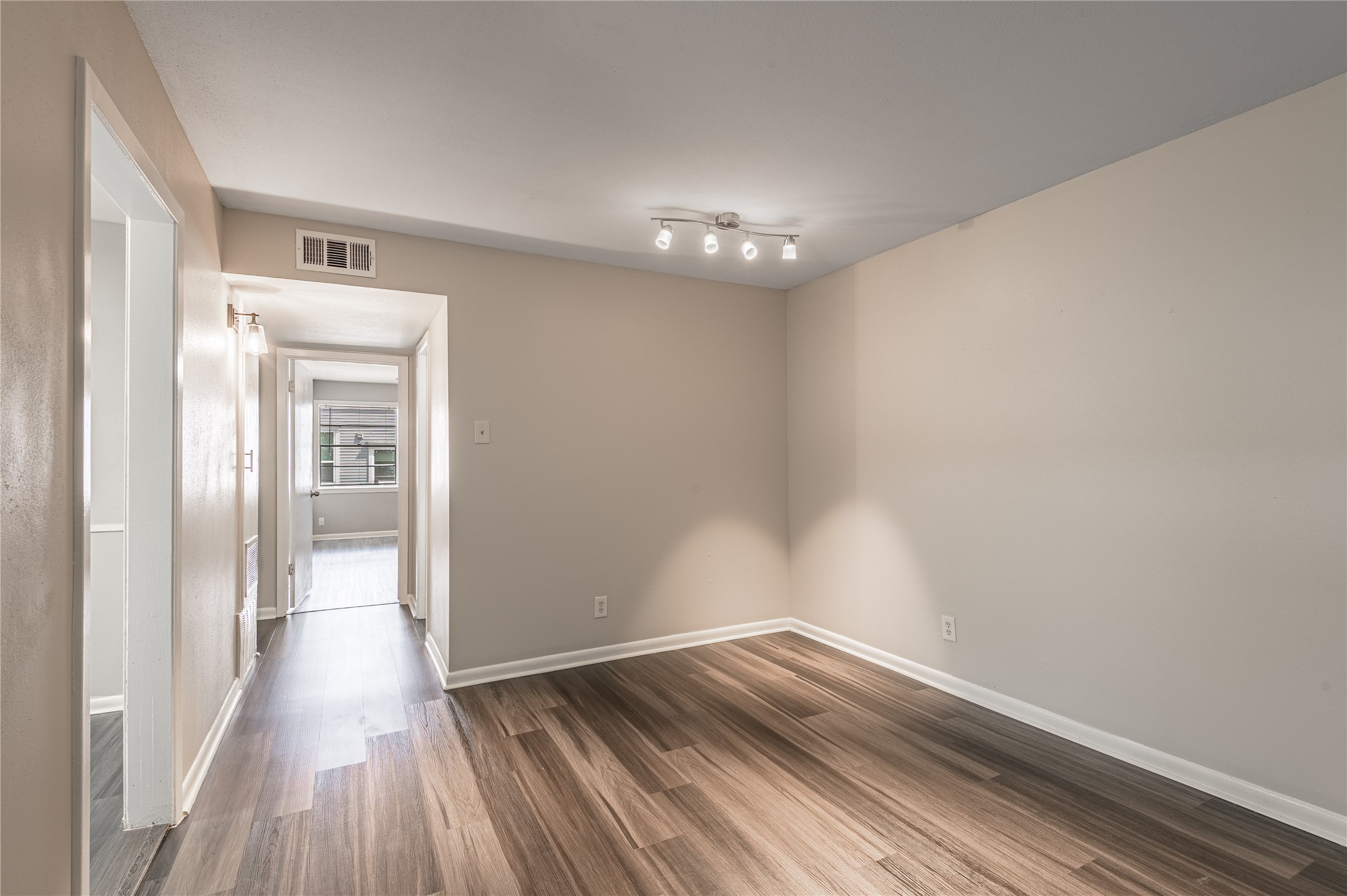 818 University Avenue, Unit 8 Huntsville, TX 77320 - Photo 5 of 22 a view of a hallway with wooden floor