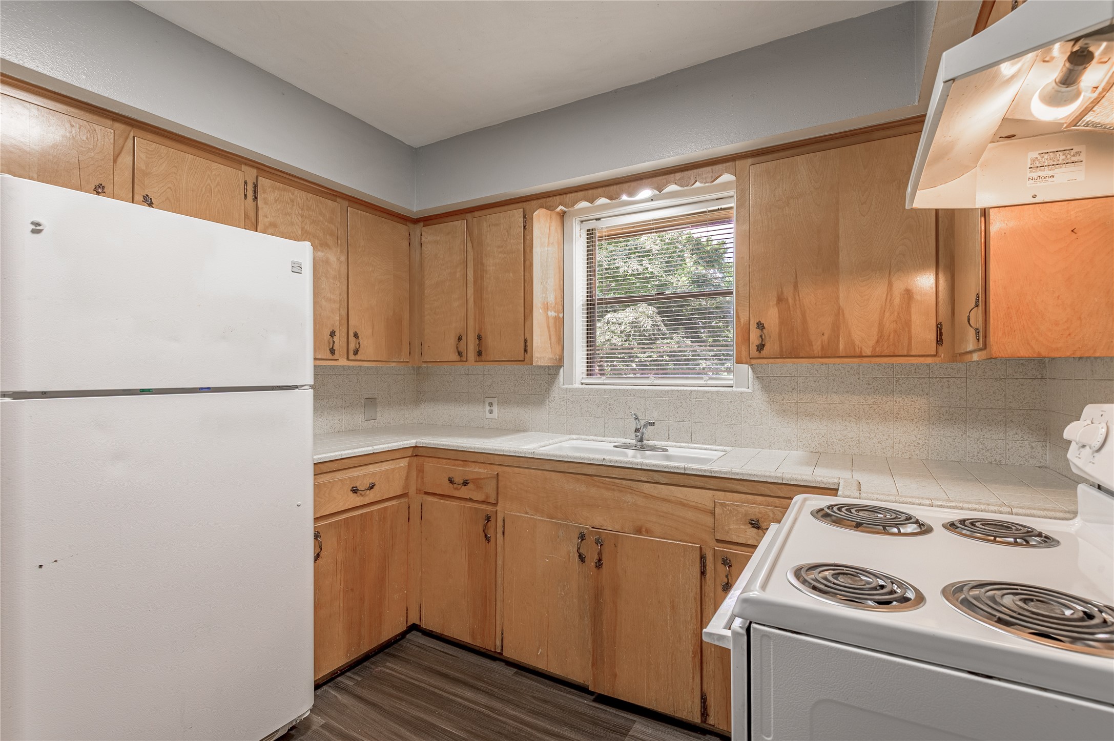 818 University Avenue, Unit 8 Huntsville, TX 77320 - Photo 8 of 22 a kitchen with a refrigerator and a sink