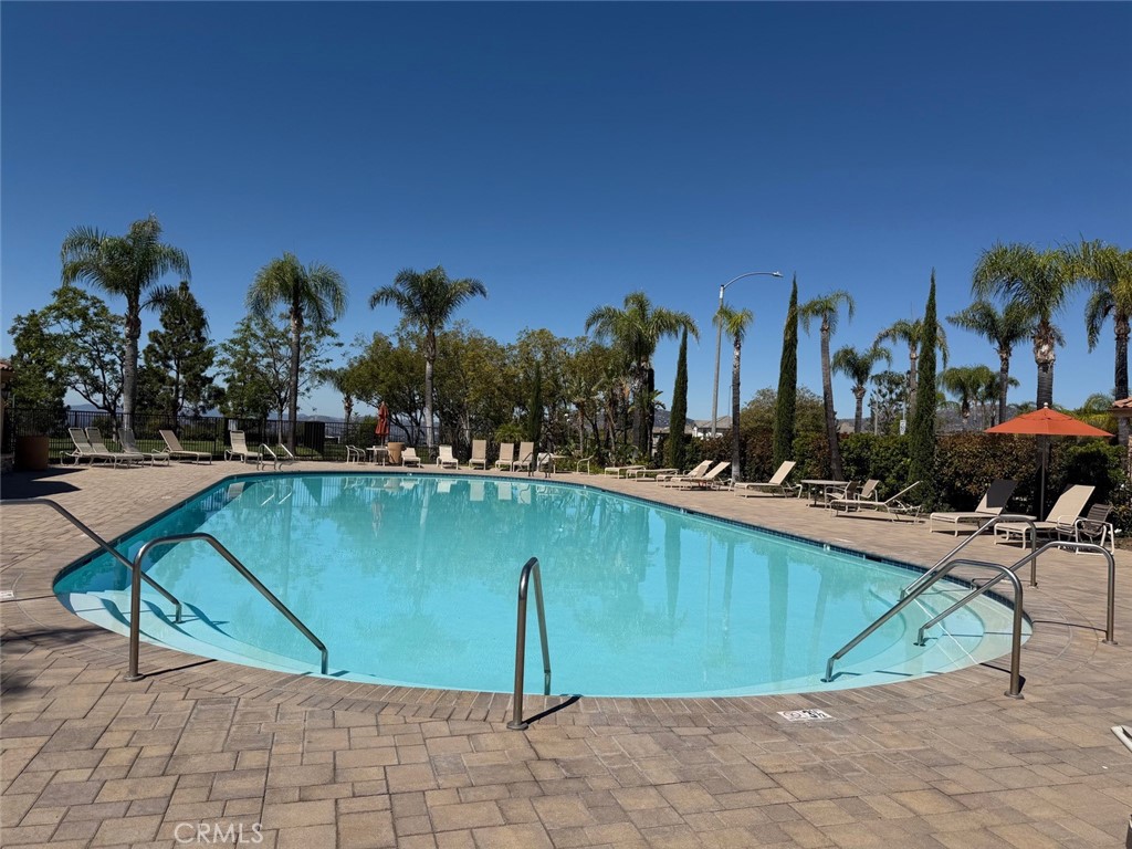 19823 Mariposa Pines Way Porter Ranch, CA 91326 - Photo 42 of 50 a view of a swimming pool with outdoor seating and plants