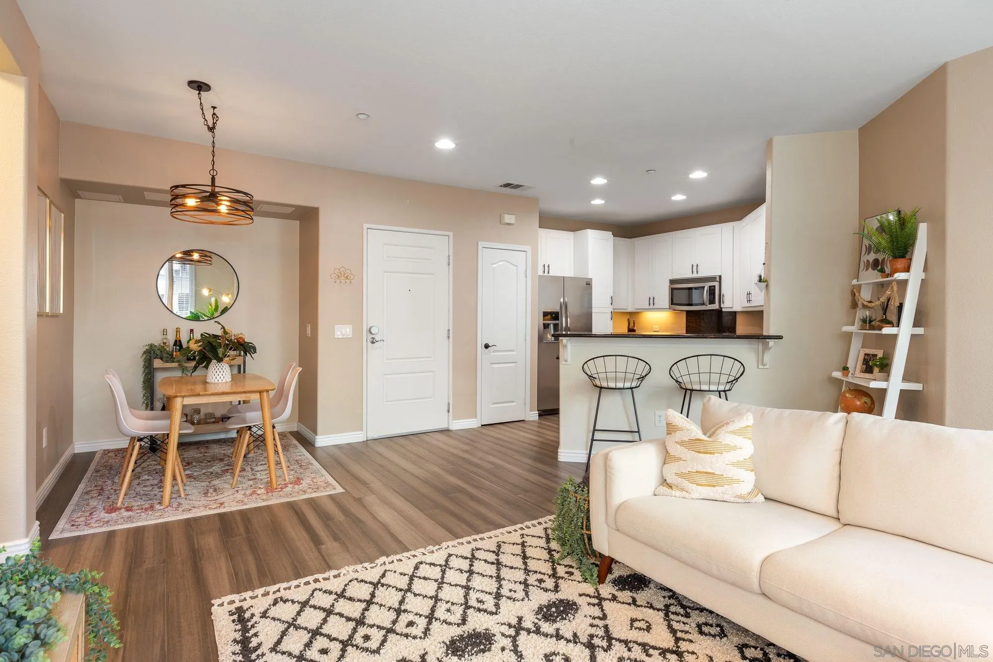 a living room with furniture and kitchen view