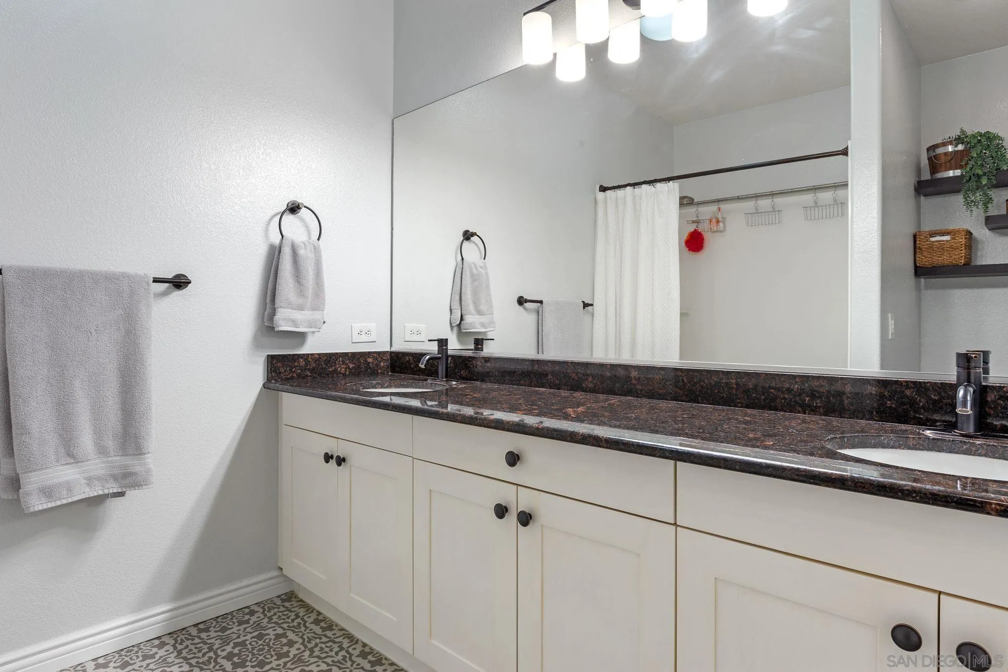 3957 30th Street, Unit 411 San Diego, CA 92104 - Photo 12 of 23 a bathroom with a sink and a mirror