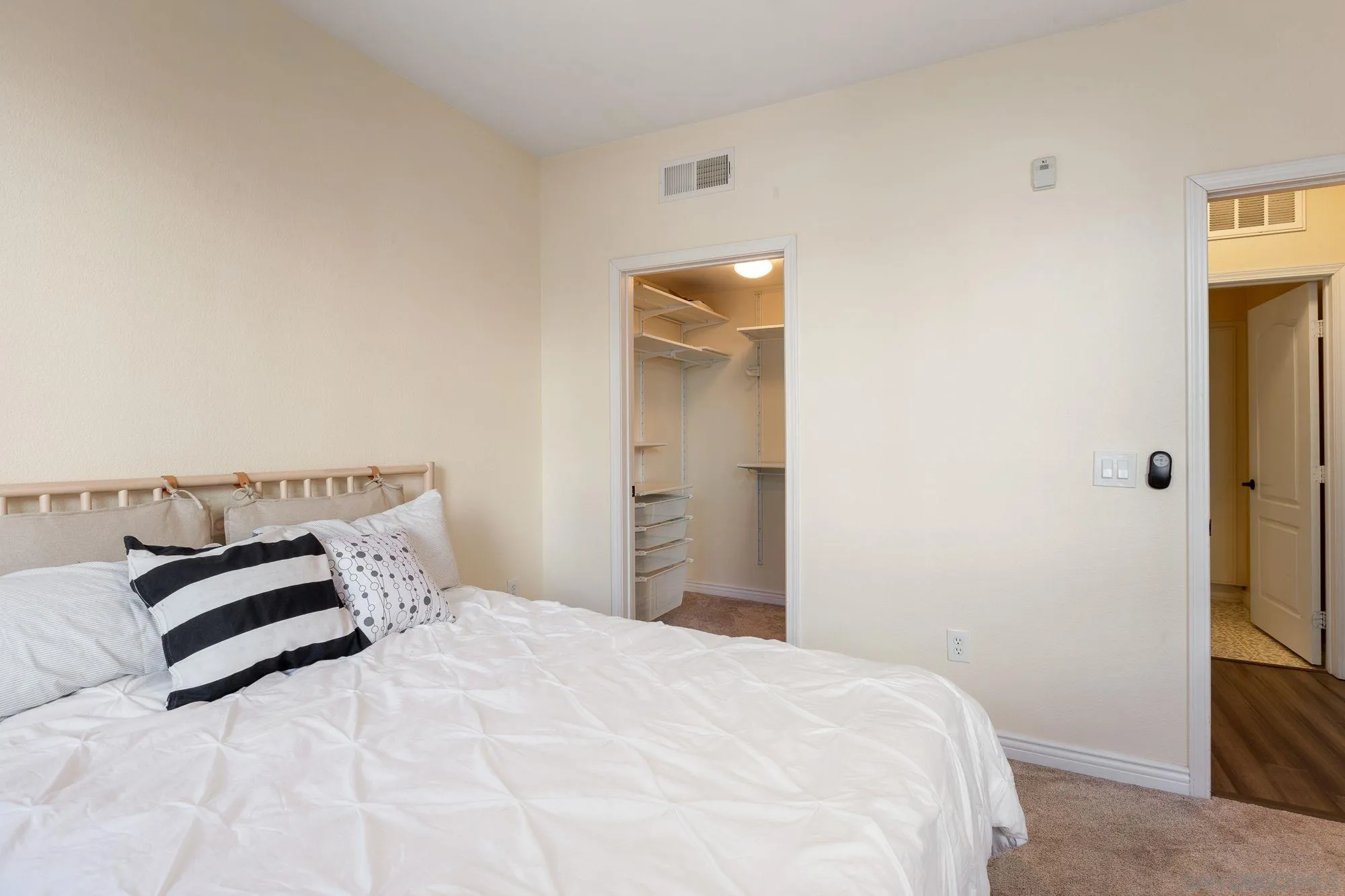 3957 30th Street, Unit 411 San Diego, CA 92104 - Photo 14 of 23 a bedroom with a bed and a night stand