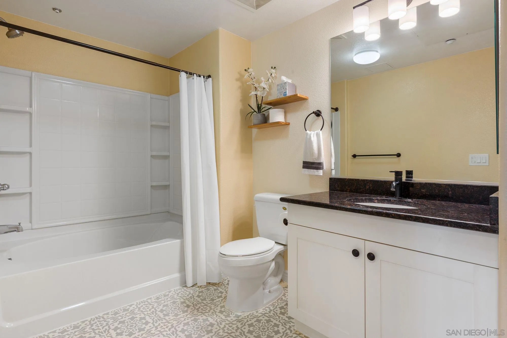 3957 30th Street, Unit 411 San Diego, CA 92104 - Photo 17 of 23 a bathroom with a granite countertop sink a toilet and bathtub
