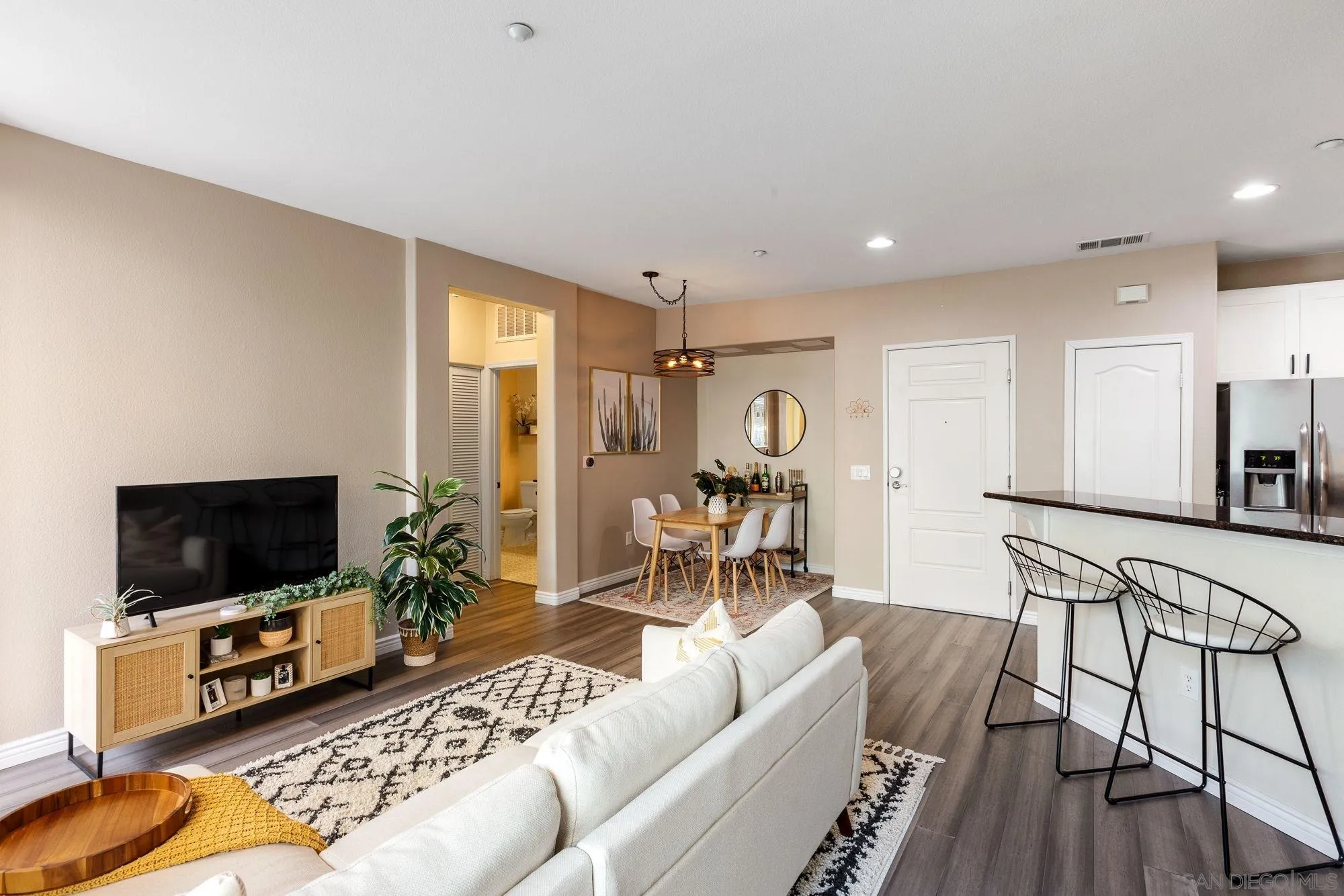 3957 30th Street, Unit 411 San Diego, CA 92104 - Photo 3 of 23 a living room with furniture and a flat screen tv