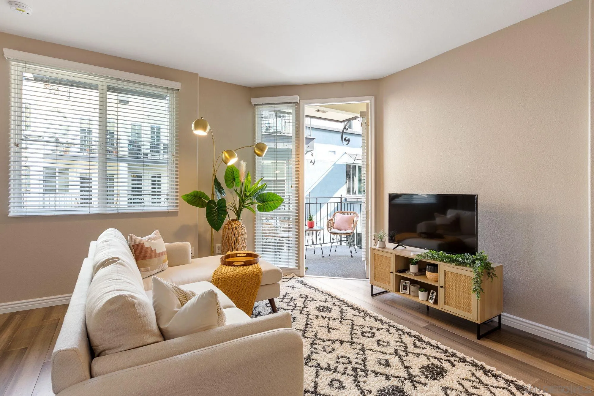 3957 30th Street, Unit 411 San Diego, CA 92104 - Photo 8 of 23 a living room with furniture and a flat screen tv