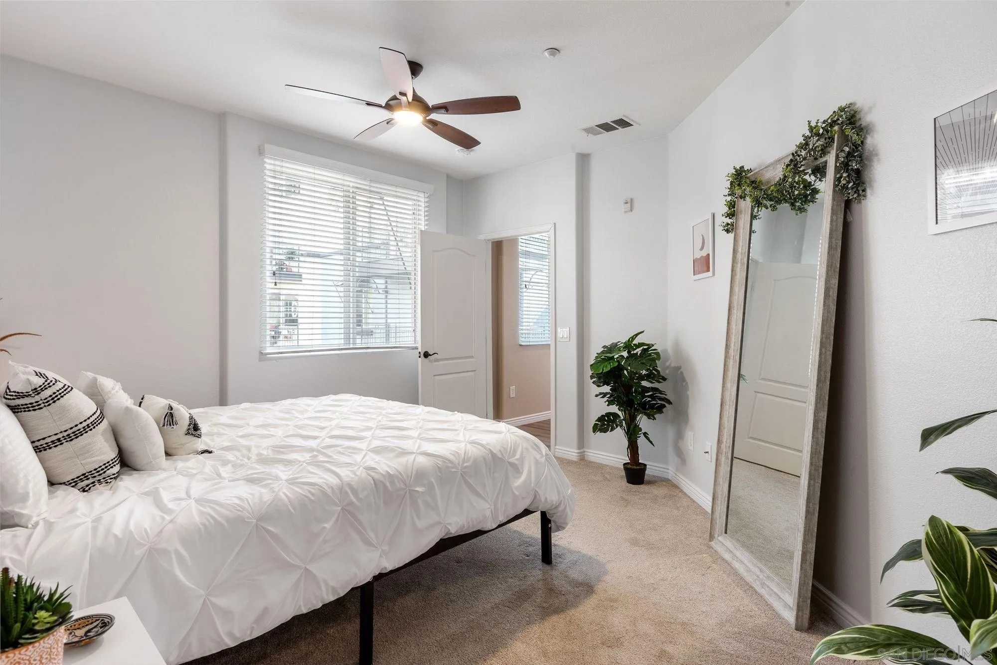 3957 30th Street, Unit 411 San Diego, CA 92104 - Photo 10 of 23 a bedroom with a large bed and a chandelier