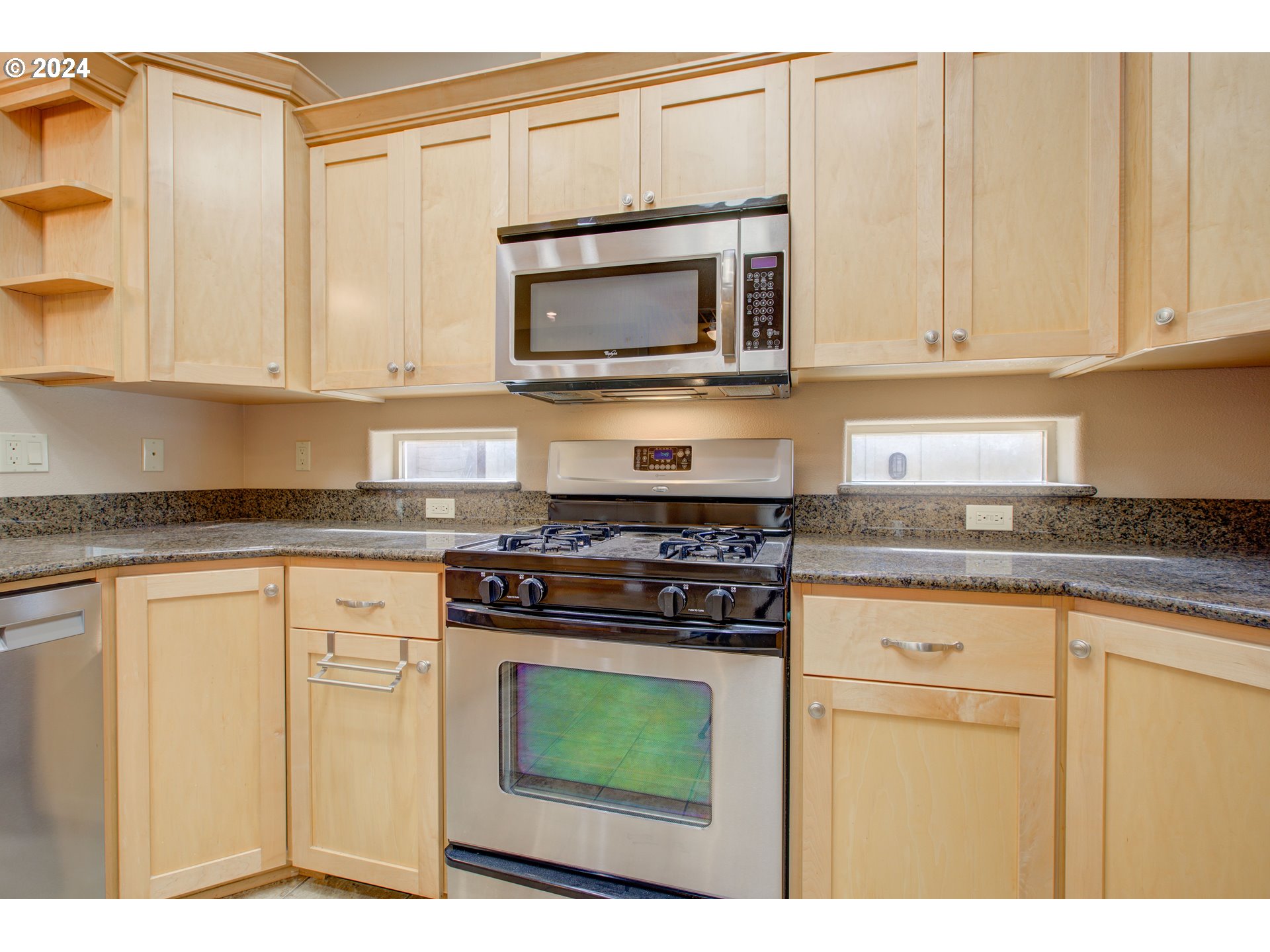 436 Backwater Loop Sutherlin, OR 97479 - Photo 15 of 46 a kitchen with stainless steel appliances granite countertop a stove a microwave and a sink