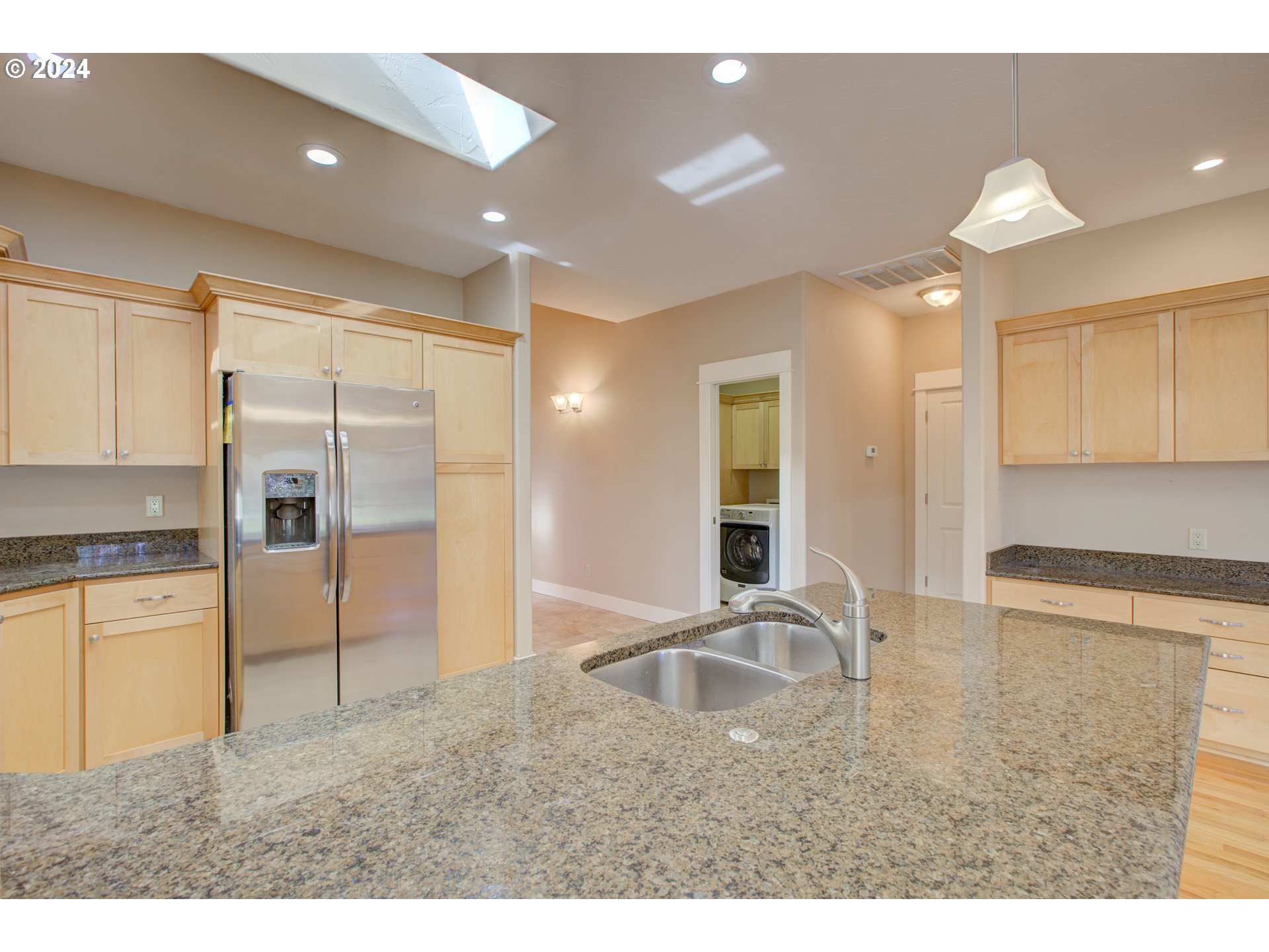 436 Backwater Loop Sutherlin, OR 97479 - Photo 17 of 46 a kitchen with granite countertop a refrigerator a sink a stove and cabinets