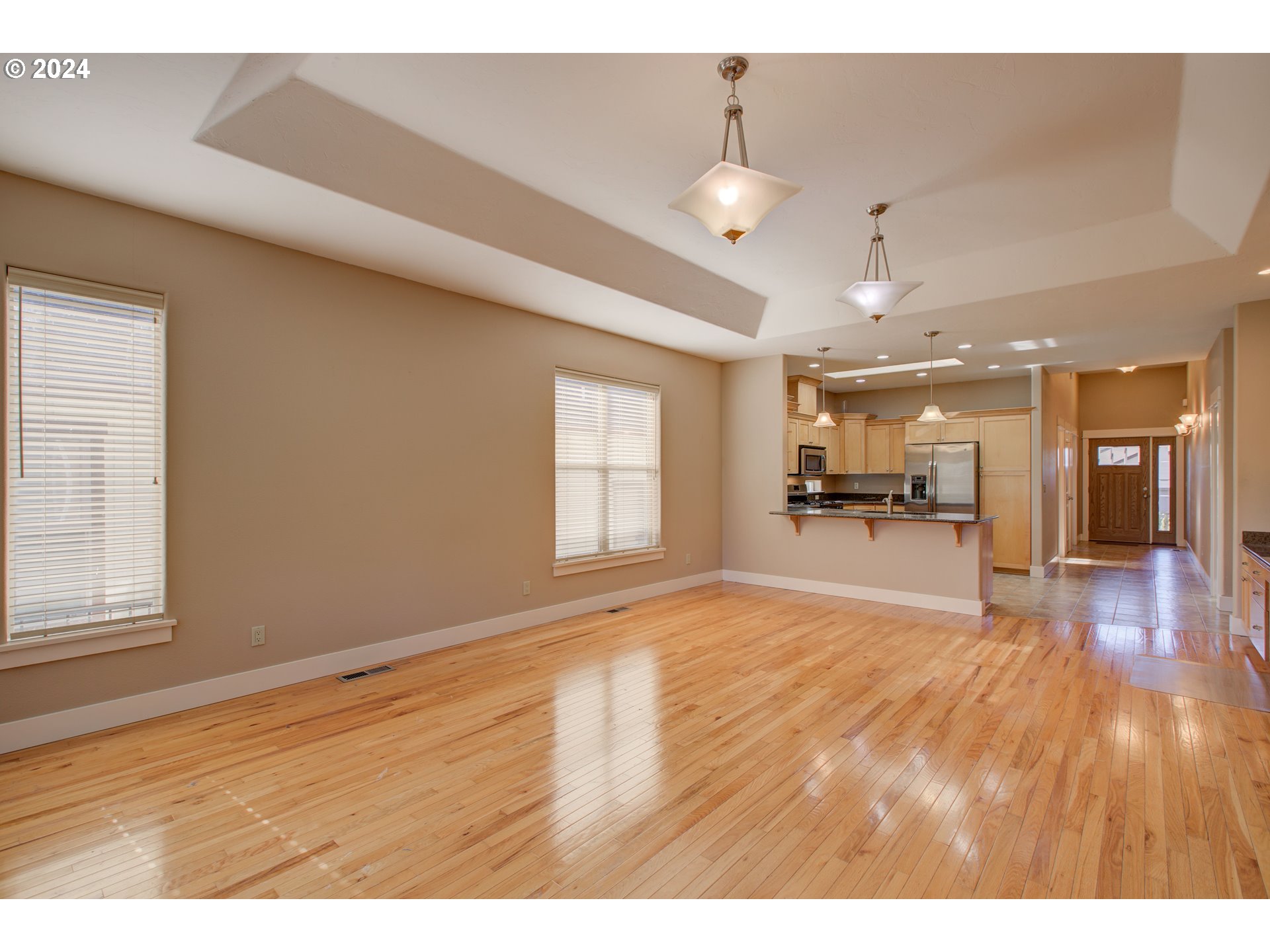 436 Backwater Loop Sutherlin, OR 97479 - Photo 9 of 46 a view of an empty room and kitchen with wooden floor