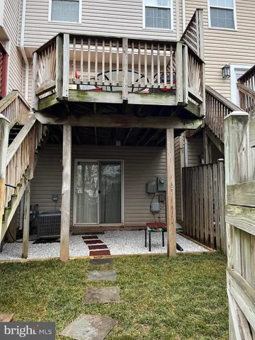 a view of a house with backyard porch and sitting area