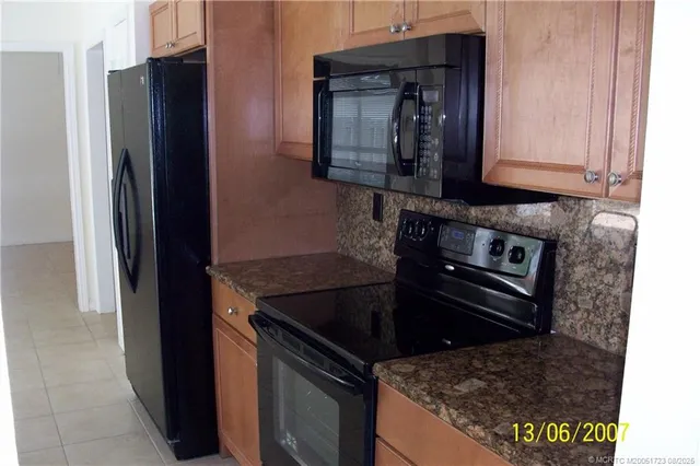 a kitchen with granite countertop a stove and a microwave