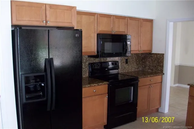 a kitchen with a refrigerator stove and microwave