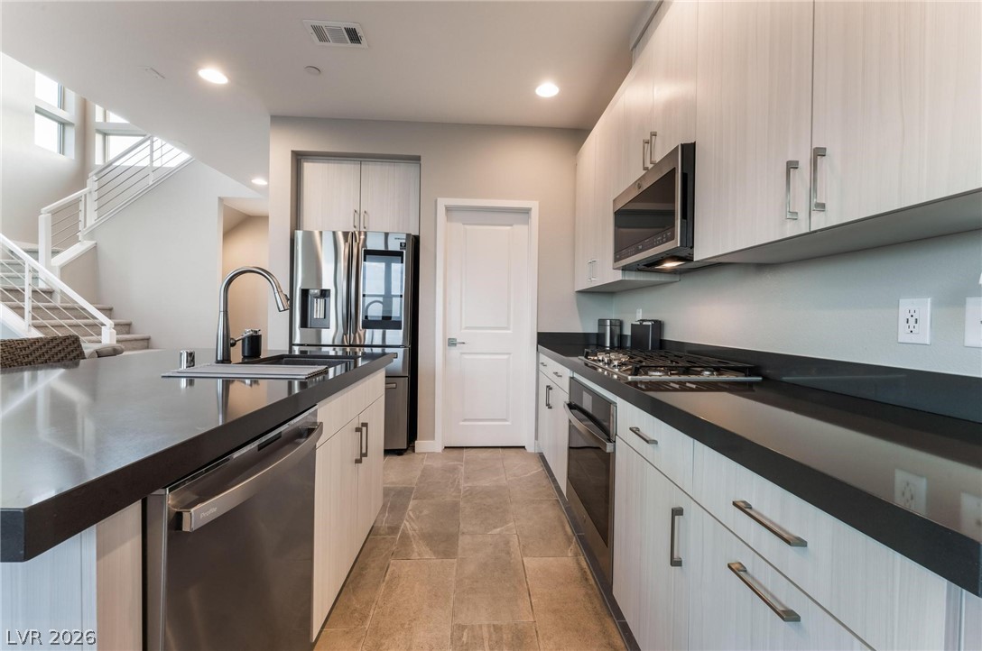 654 Amethyst Point Way Las Vegas, NV 89138 - Photo 19 of 50 2nd Level Kitchen w/ Upgraded Cabinets, quartz countertops & Stainless Steel Appliances. Walk in Pantry