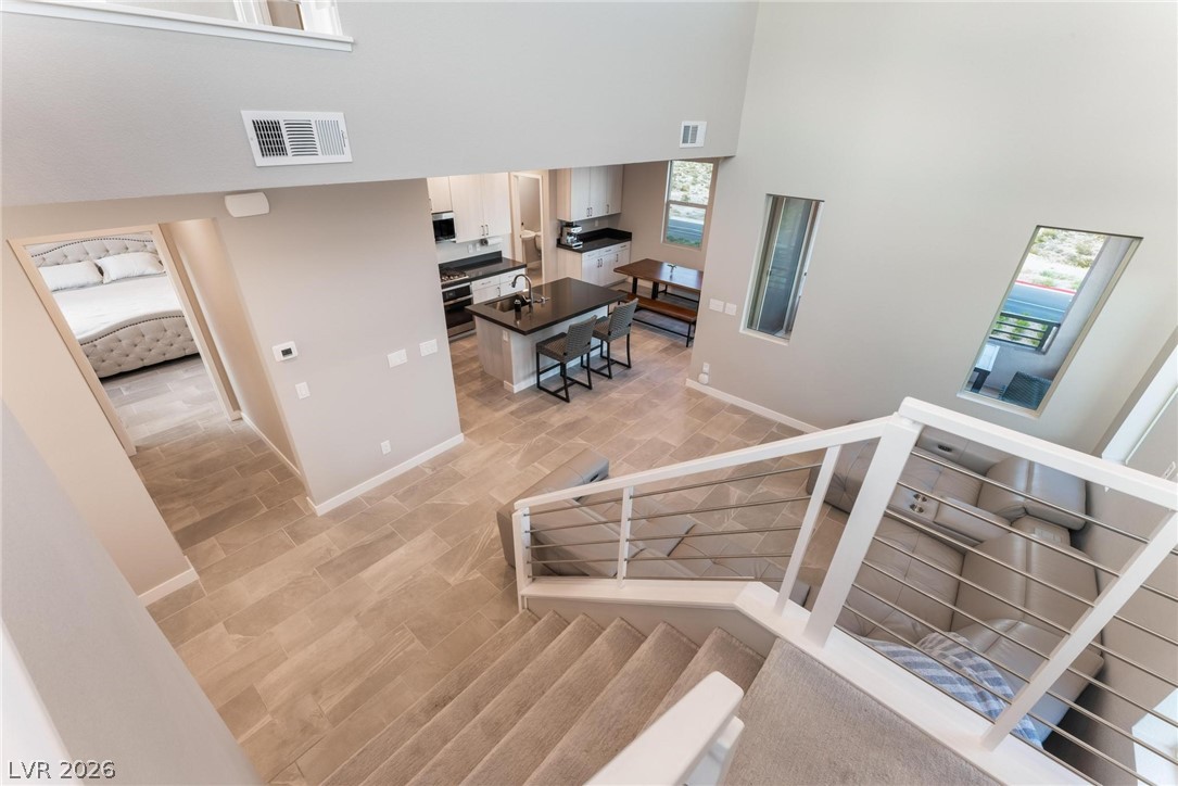 654 Amethyst Point Way Las Vegas, NV 89138 - Photo 26 of 50 Family Room, Kitchen, Dining View from Stairway leading to Level #3