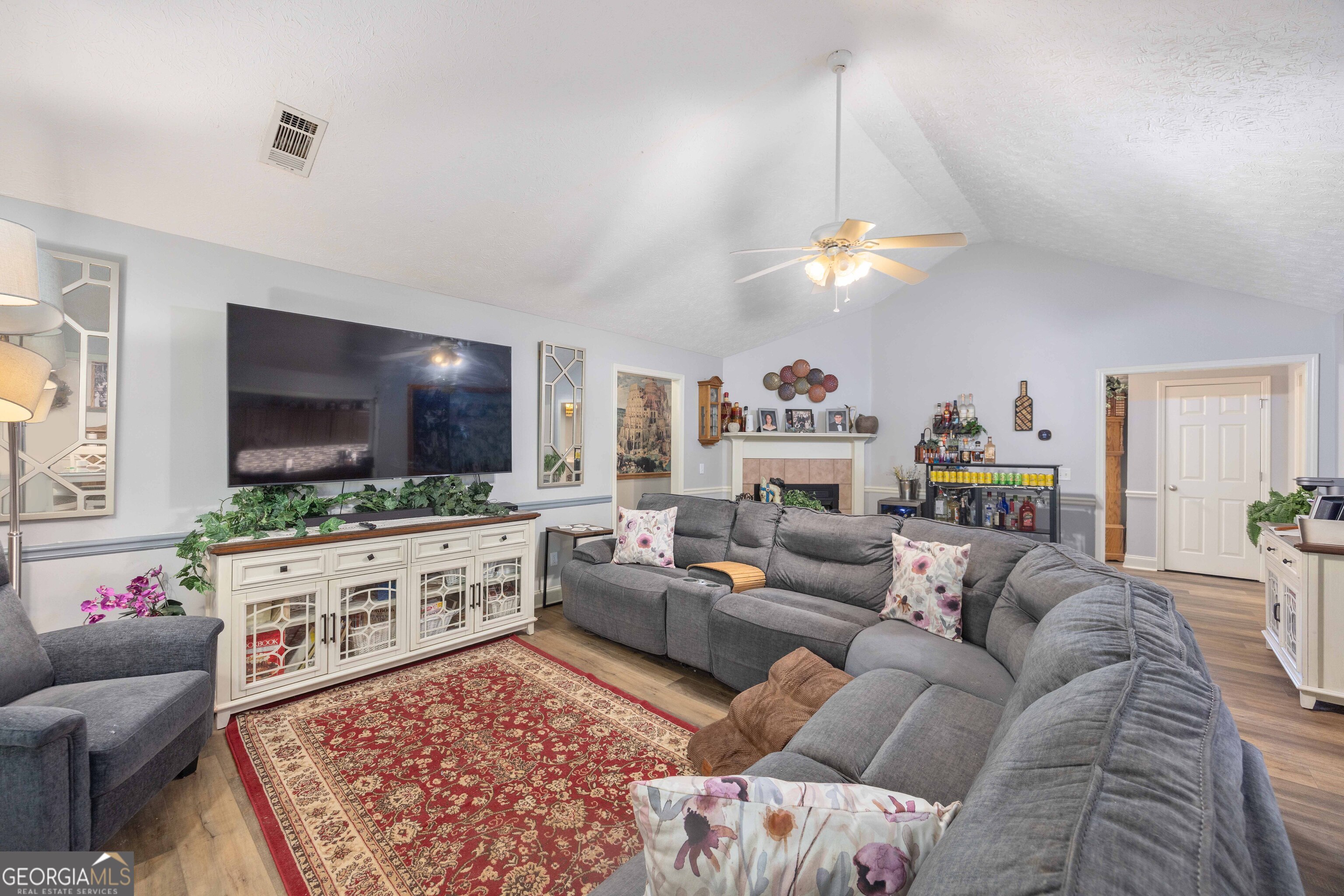 2083 Johnson Mill Road Hamilton, GA 31811 - Photo 17 of 30 a living room with furniture a flat screen tv and a chandelier