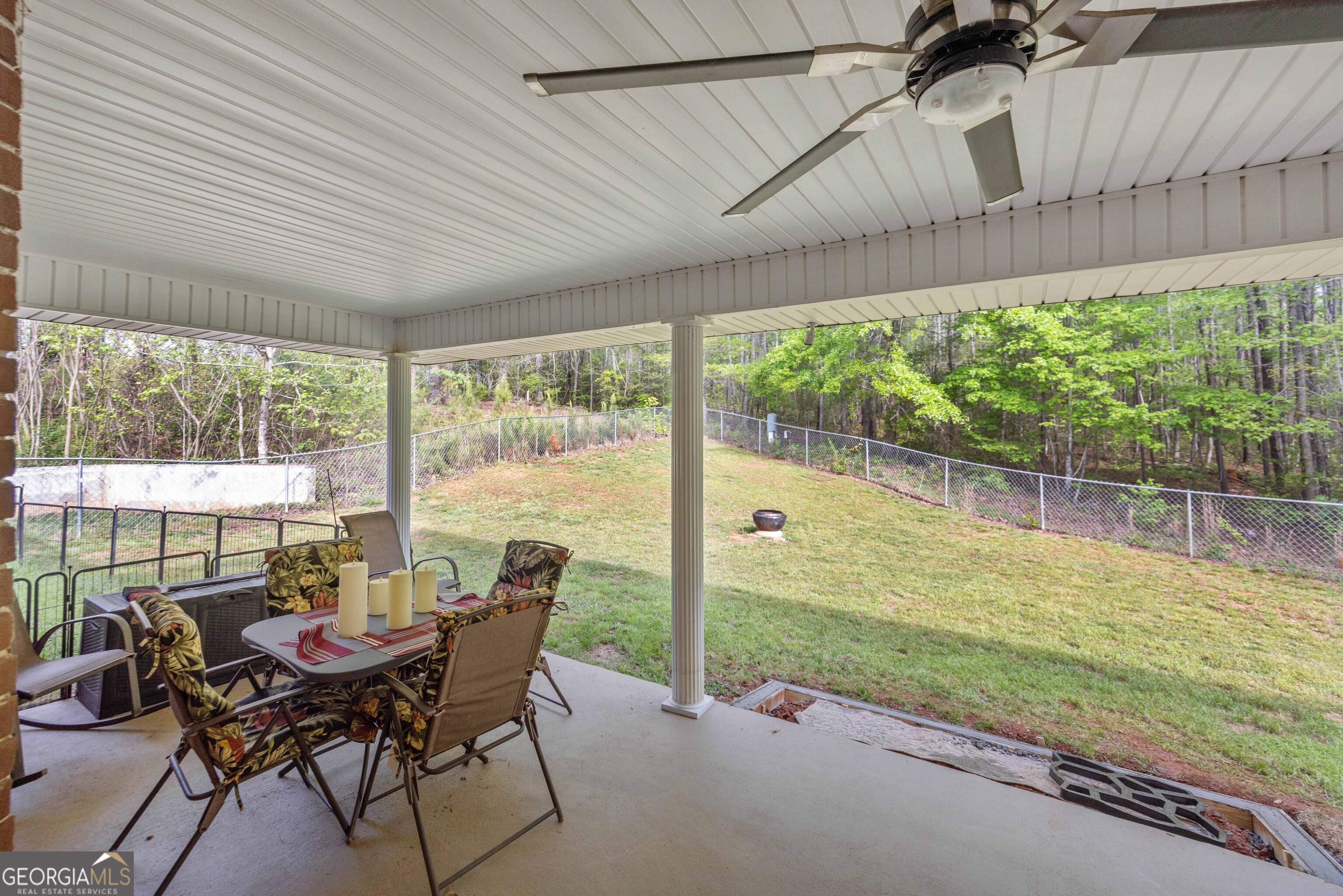 2083 Johnson Mill Road Hamilton, GA 31811 - Photo 24 of 30 a view of a patio with a table chairs and a backyard