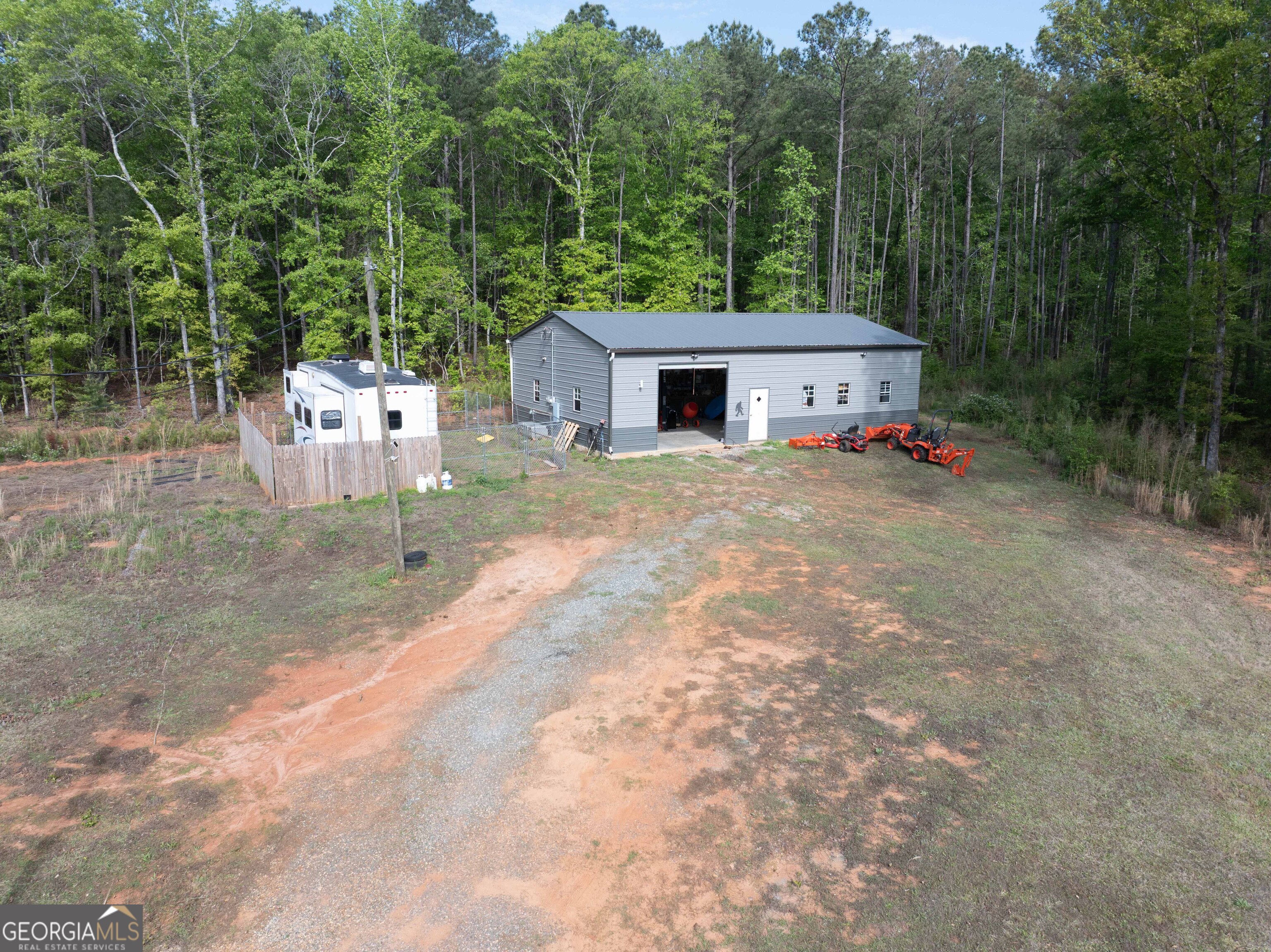 2083 Johnson Mill Road Hamilton, GA 31811 - Photo 27 of 30 a view of a house with a backyard and trees