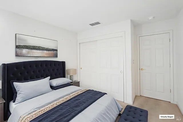 a bedroom with a bed and a night stand