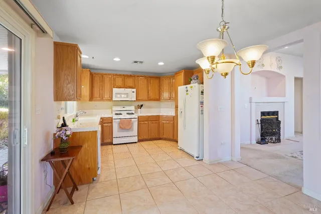 a kitchen with a refrigerator a center island a stove and a cabinets
