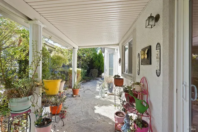 a view of a patio with table and chairs and potted plants