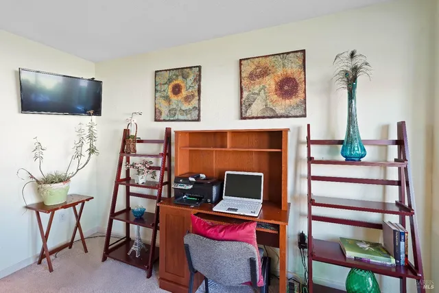 a room with furniture mirror and a flat screen tv